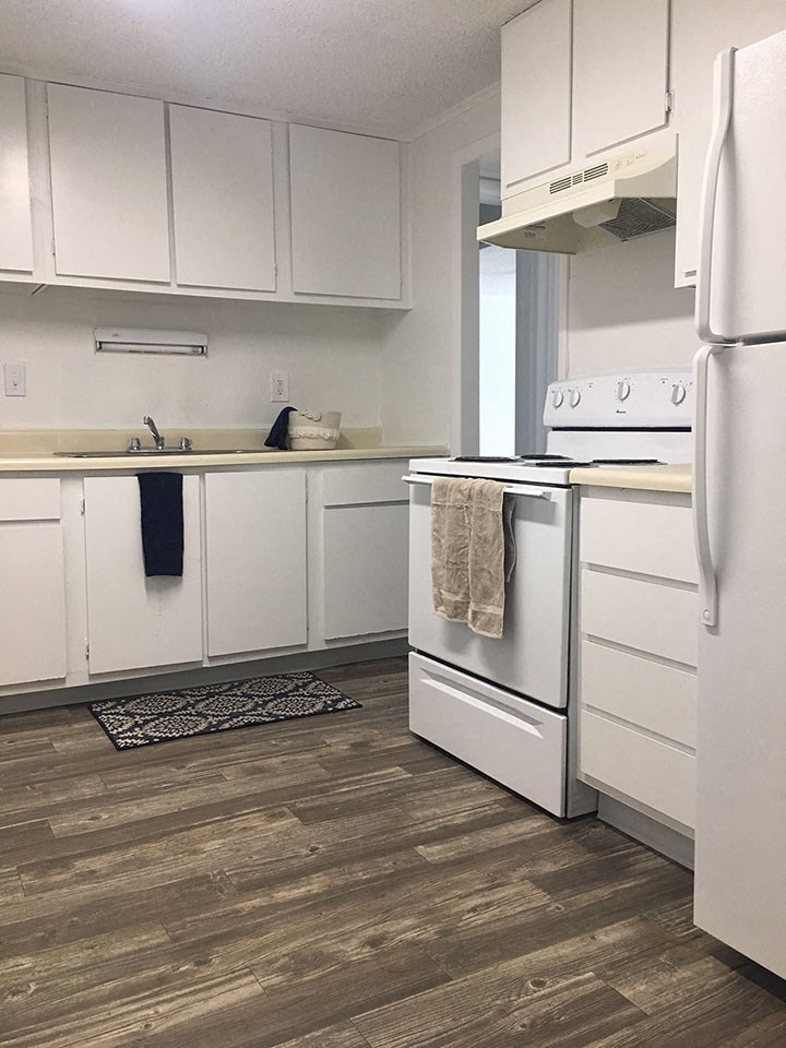 a kitchen with white appliances and white cabinets