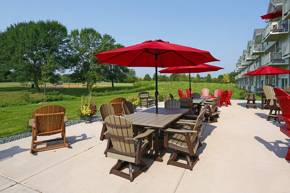 an outdoor patio with tables and chairs and umbrellas