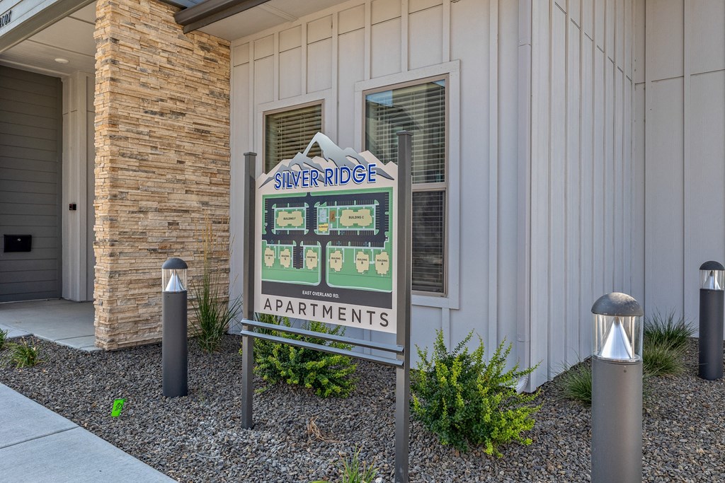 a sign in front of a building with a baseball scoreboard