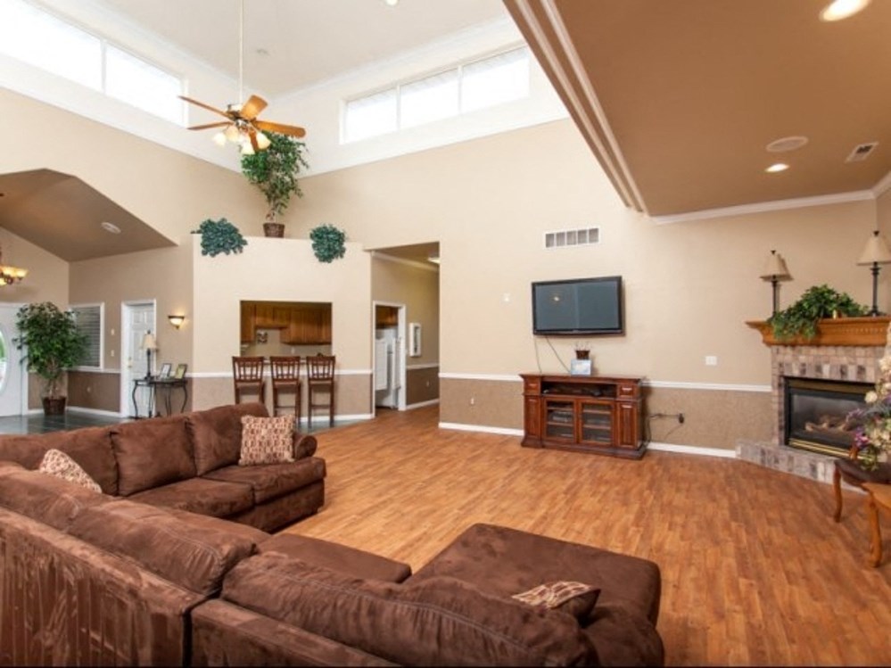 a large living room with a couch and a tv