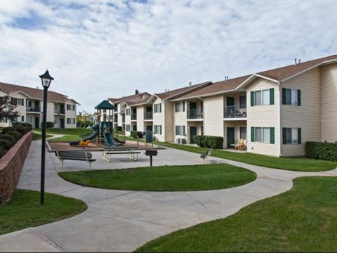 a group of apartments with a playground in front of them