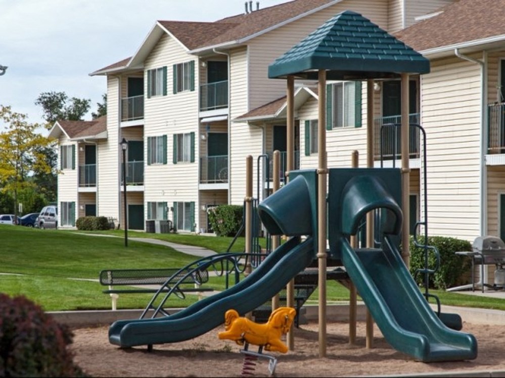 a playground in front of an apartment complex