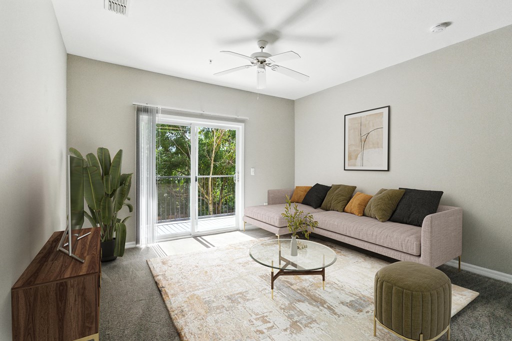 A living room with a couch, a coffee table, and a ceiling fan.
