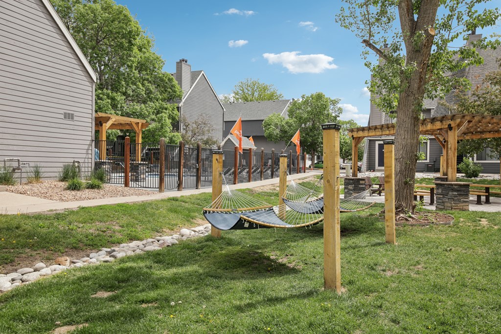 A playground with a hammock and a slide.