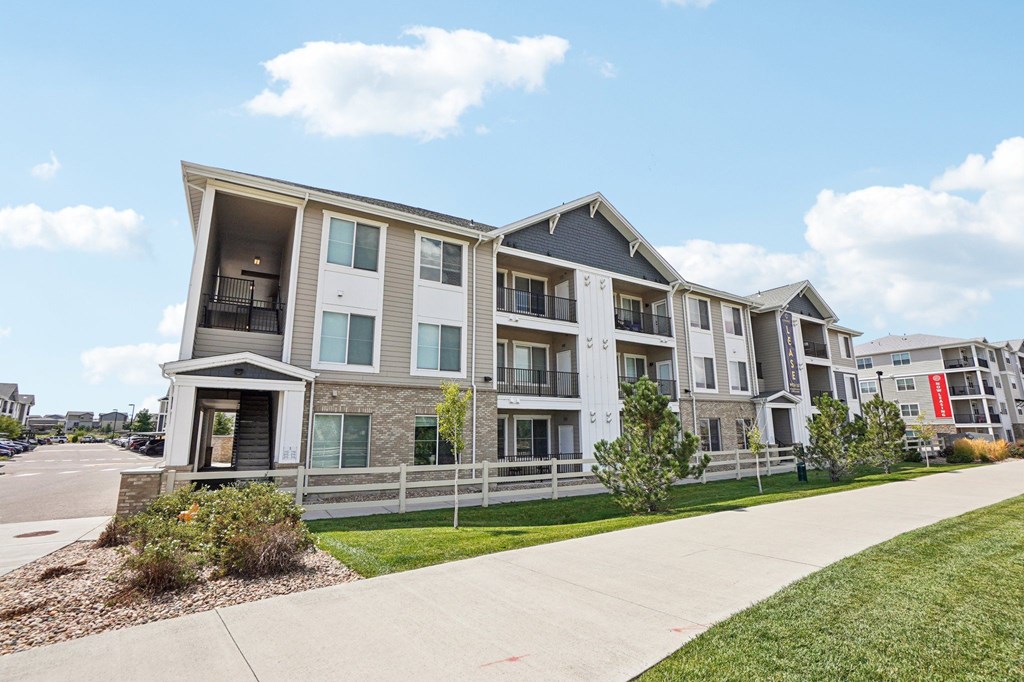 Apartment building with a clear blue sky above. at Connect at First Creek Apartments, Denver, CO