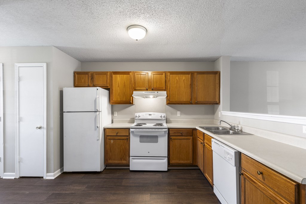 the preserve at ballantyne commons apartment kitchen with white appliances and wooden cabinets