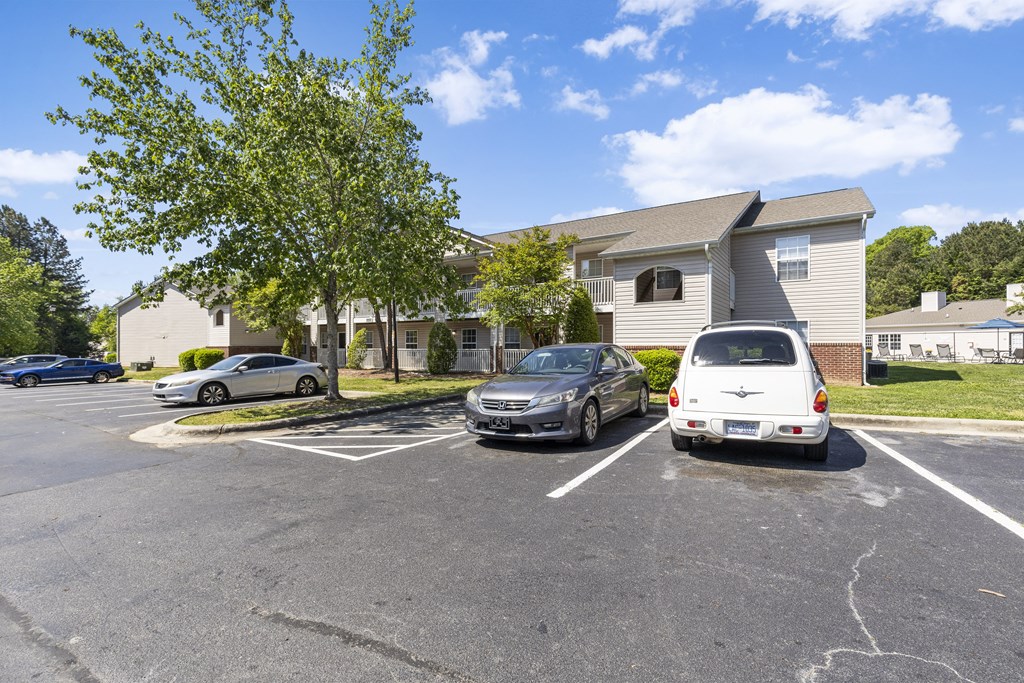 a parking lot with cars in front of a house