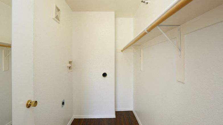 a white room with a closet and a white door