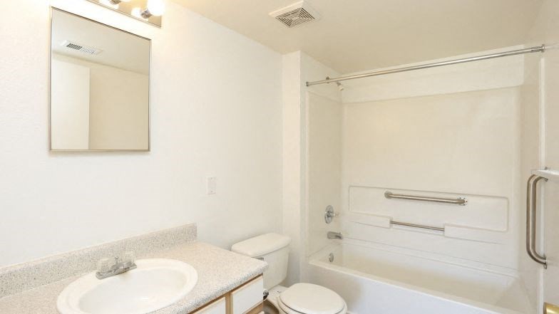 a white bathroom with a sink and a toilet