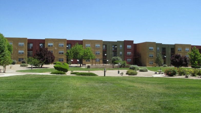 a large lawn in front of an apartment building