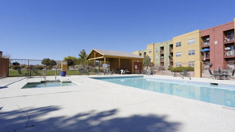 a swimming pool with a building in the background