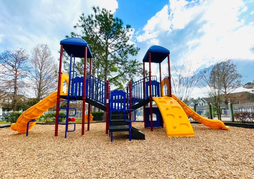 a playground with a swing set and slides