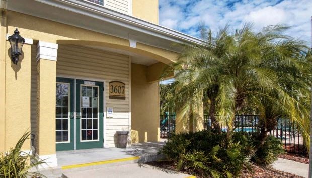 a building with a palm tree in front of it