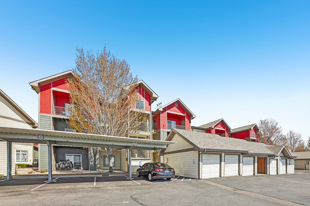 A parking lot in front of a building with a car parked. at Stetson Meadows Apartments, Colorado