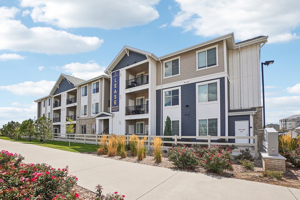 A modern apartment building with the sign  at Connect at First Creek Apartments, Denver, CO, 80249