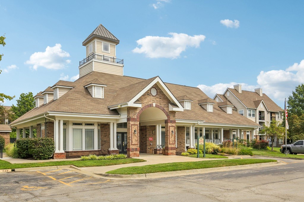 A large building with a tower and a flag on top.