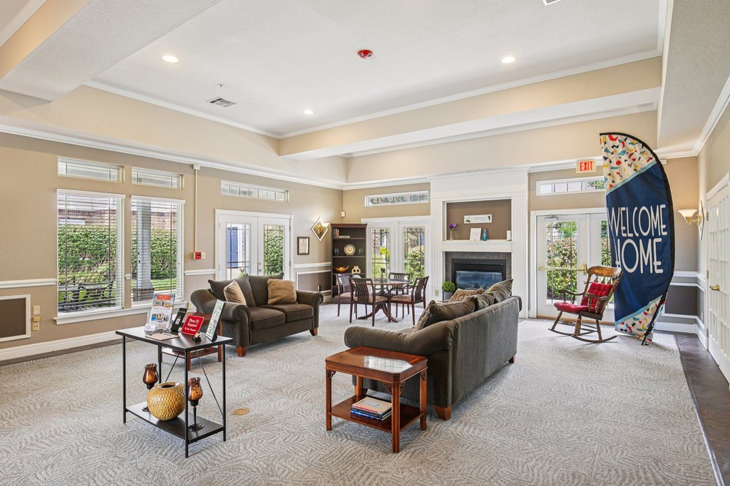 A living room with a sofa, a coffee table, and a fireplace.