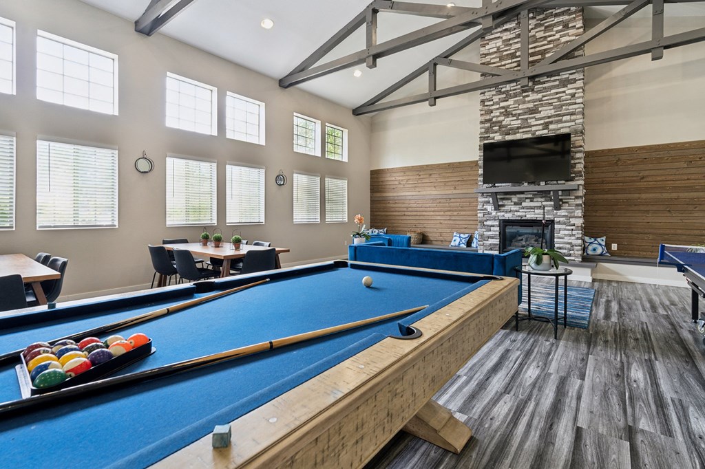 a games room with a pool table and a fireplace