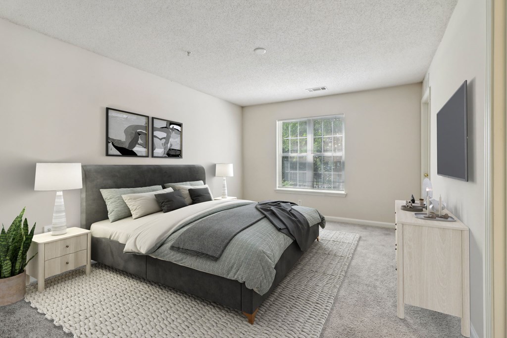 A bedroom with a large bed and a window.
