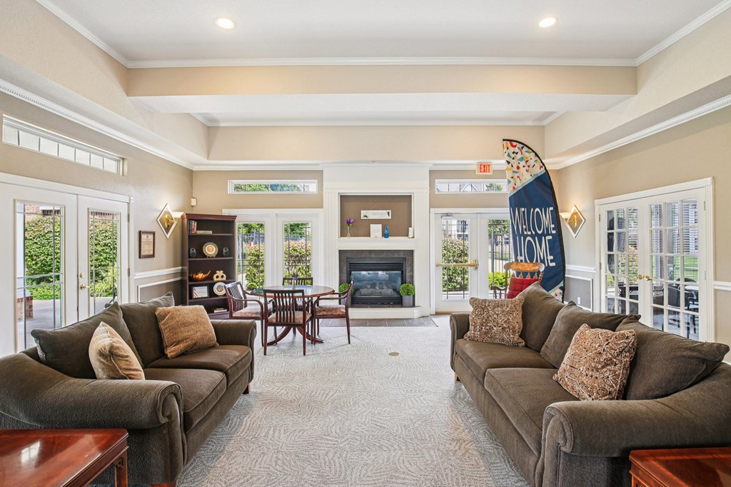 A living room with a fireplace and two couches.