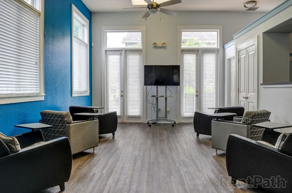 a waiting room with chairs and a tv