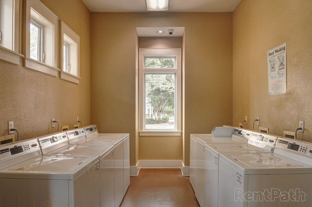 a bathroom with three sinks and a window
