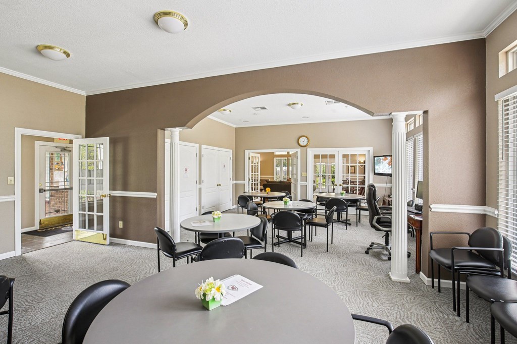 A dining room with a table set for six people.