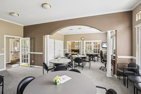 A dining room with a table set for six people.