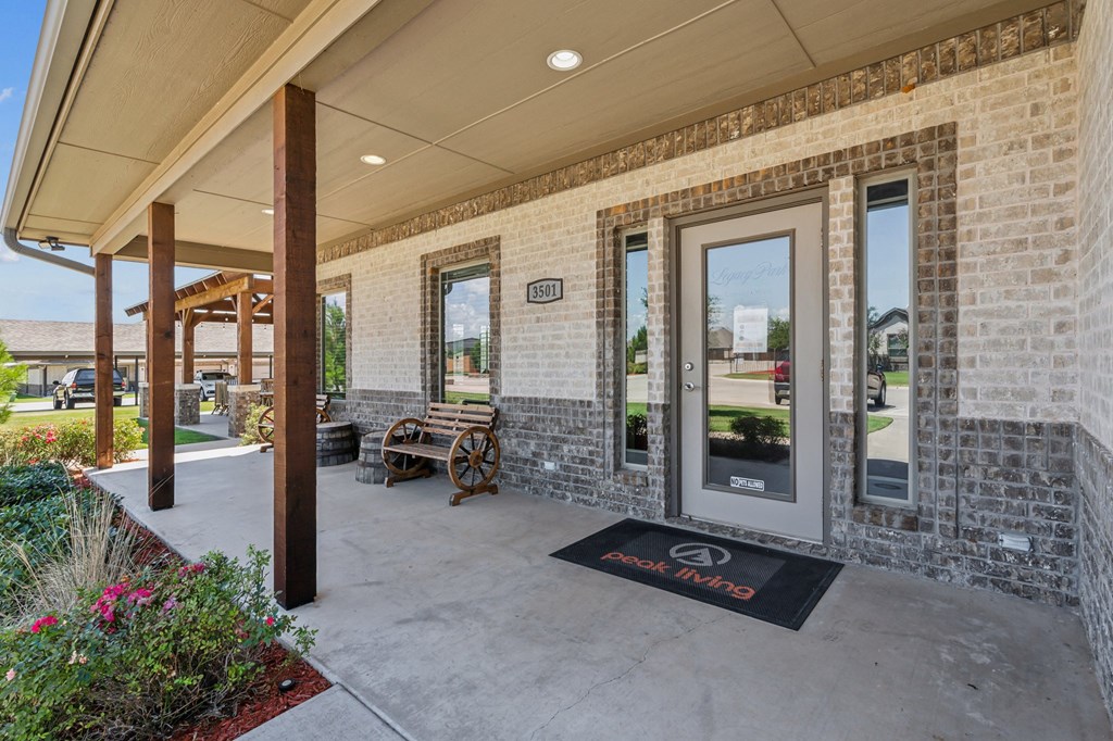 the retreat apartmentsuccessary front porch of the building with a welcome mat