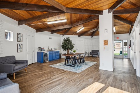 A living room with a grey couch and a wooden ceiling.