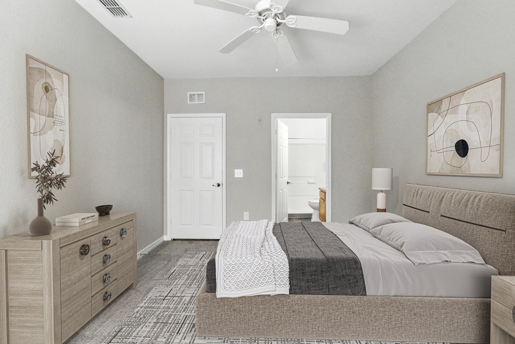 A bedroom with a bed, dresser, and ceiling fan.