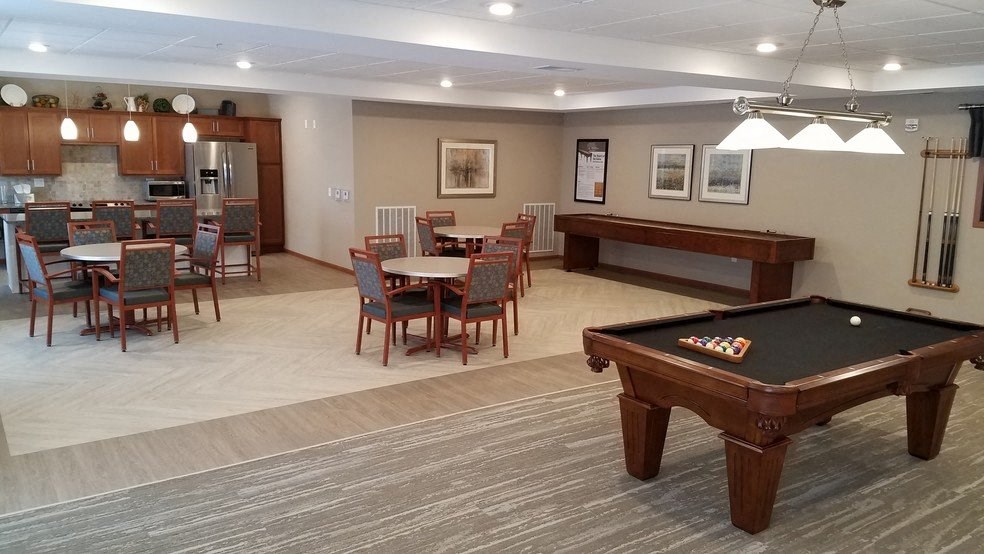 a game room with a pool table and a billiard table