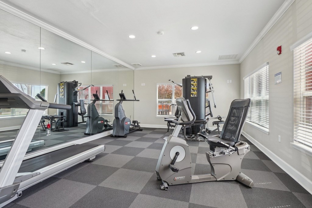 A gym with a treadmill, elliptical machines, and a weight machine. at Stetson Meadows Apartments, Colorado Springs, Colorado