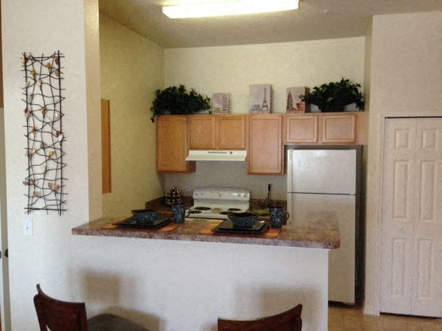 a kitchen with a counter top and a refrigerator