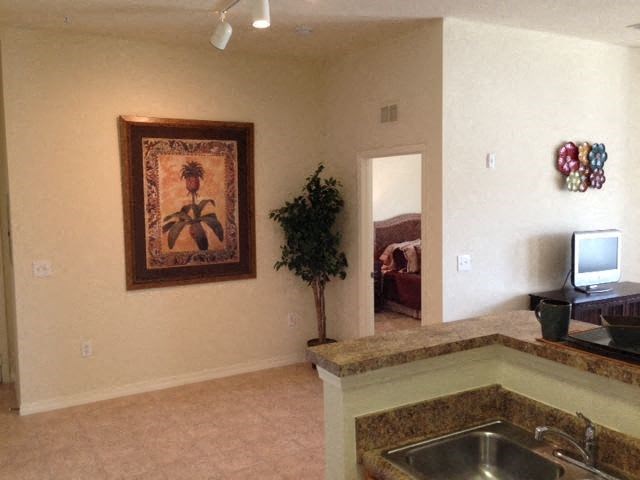a living room with a sink and a television