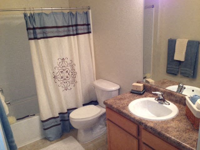 a bathroom with a sink toilet and a shower curtain