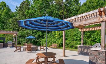 a patio with a table and chairs and an umbrella