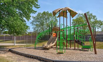 a playground with a slide and climbing equipment