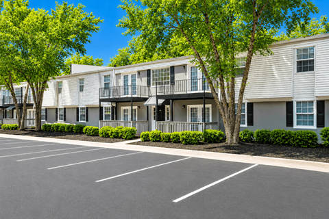 A parking lot in front of apartment buildings.