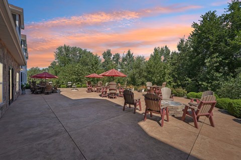 A patio with red umbrellas and chairs is set up for outdoor seating.