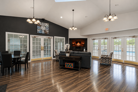A living room with a fireplace and a dining table.