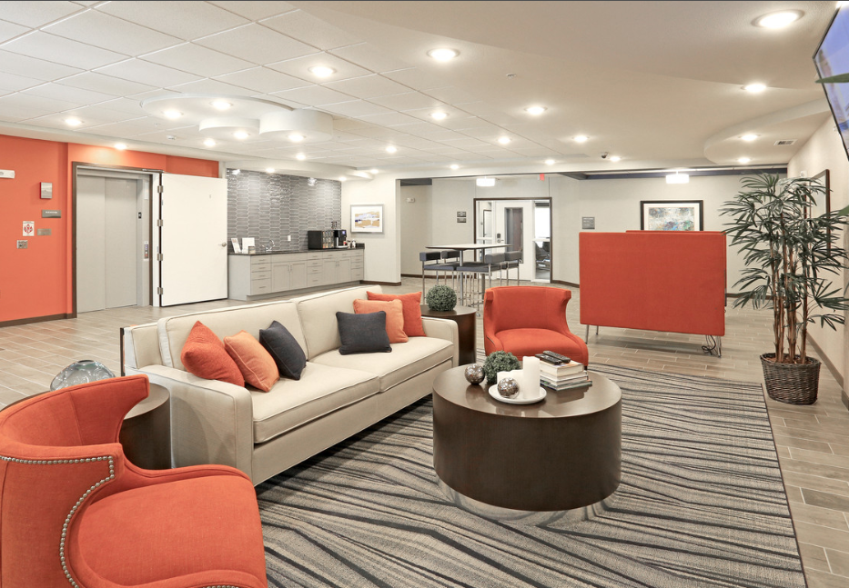 a lobby with couches and chairs and a table