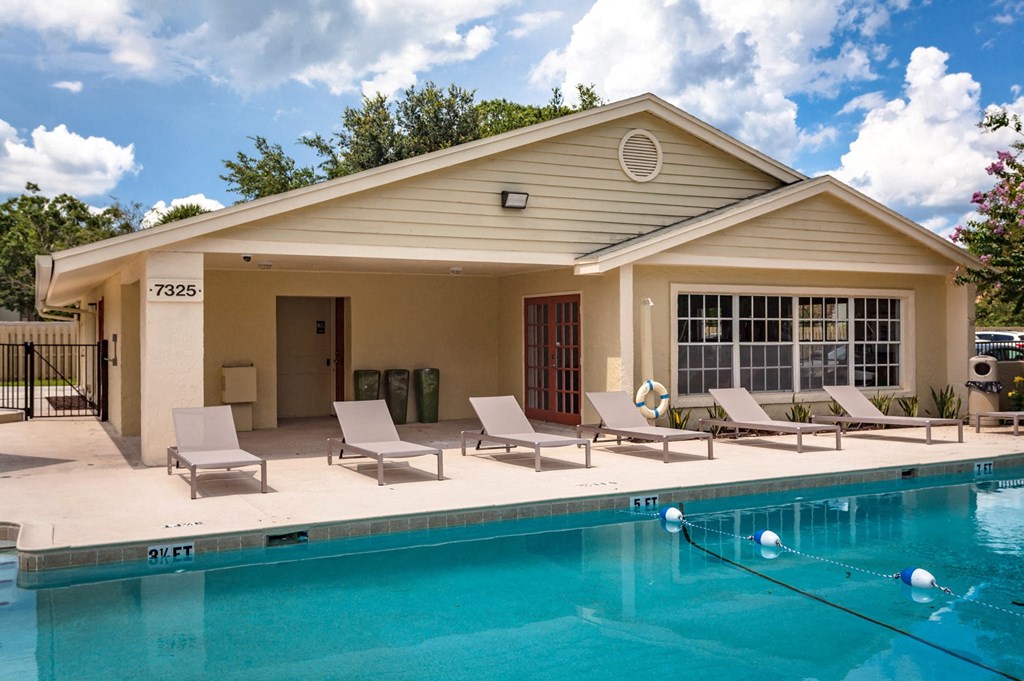 the pool and lounge chairs at the pool house at the resort at governors crossing