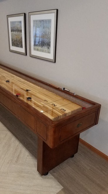 a wooden desk with two pictures on the wall