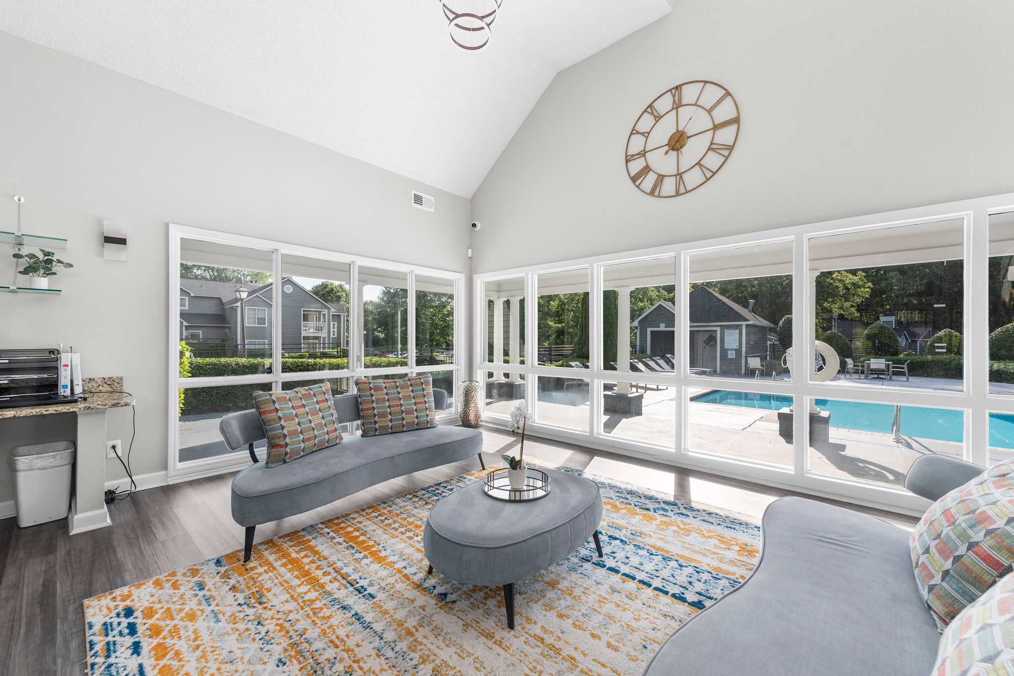 a living room with a couch and a coffee table in front of a large window