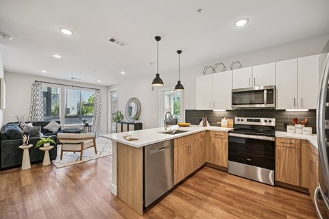 A modern kitchen with wooden cabinets and stainless steel appliances.
