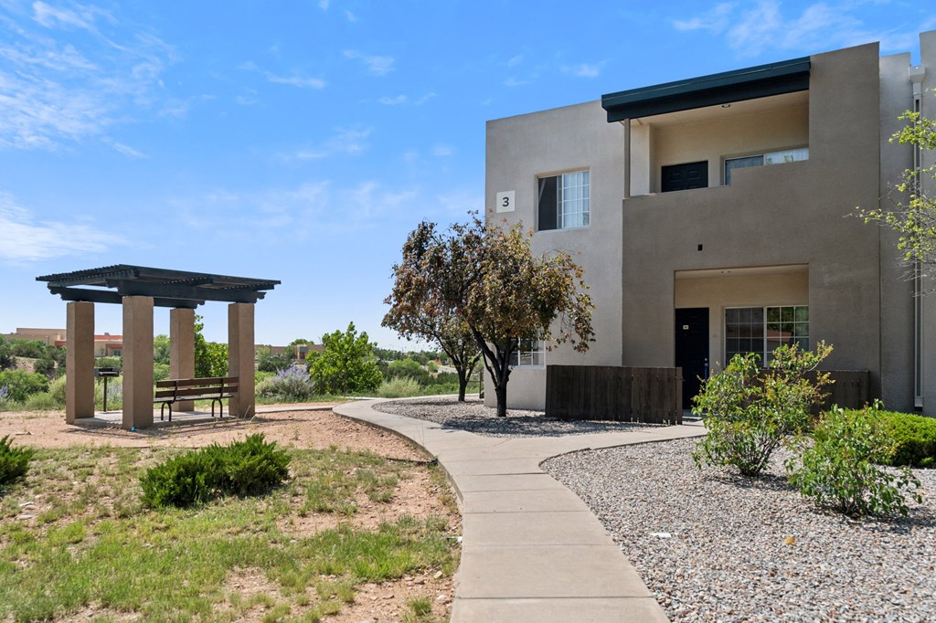 a house with a walkway and a bench in front of it a house with a walkway and a bench in front of it at Vista Linda, New Mexico