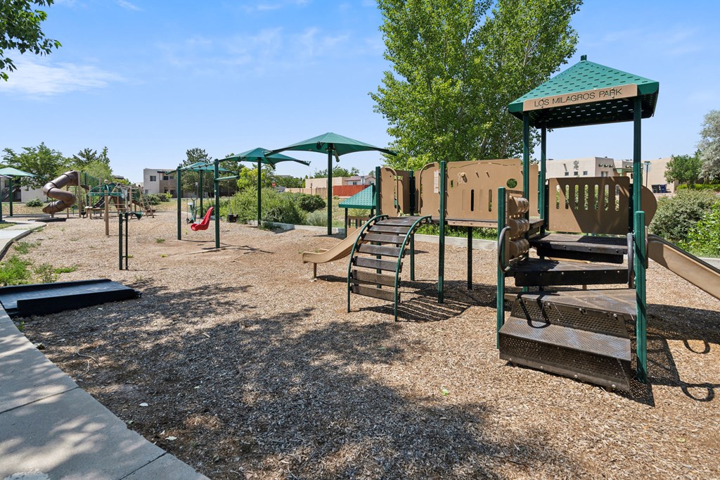a playground with a swing set and other playground equipment a playground with a swing set and other playground equipment at Vista Linda, New Mexico 87507