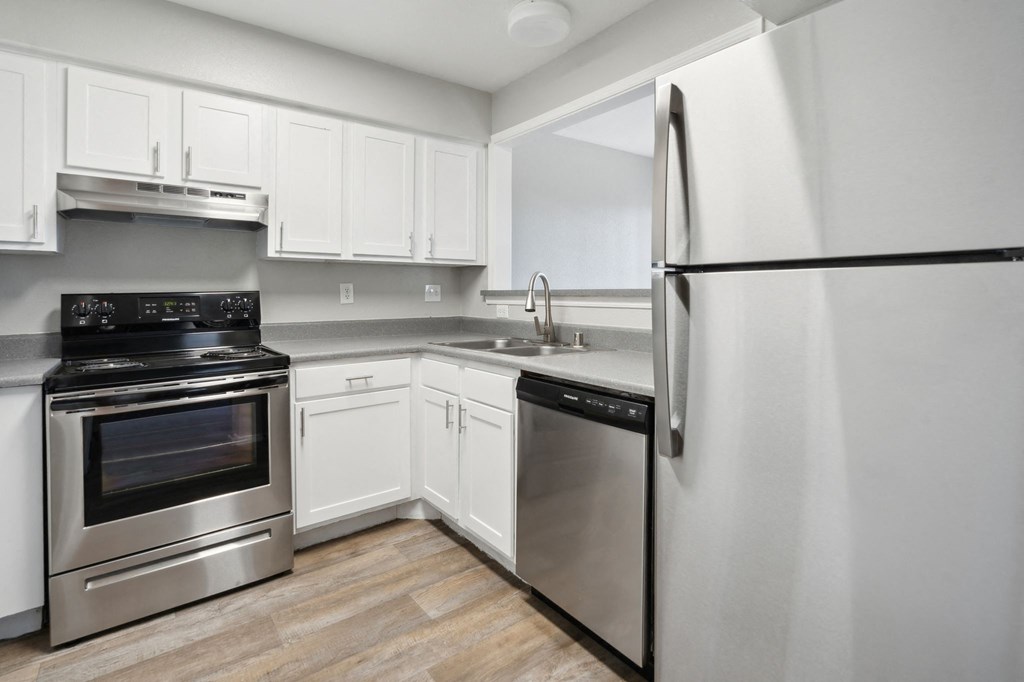a kitchen with stainless steel appliances and white cabinets a kitchen with stainless steel appliances and white cabinets at Vista Linda, New Mexico