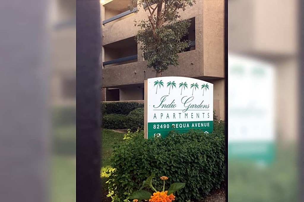 a sign in front of an apartment building